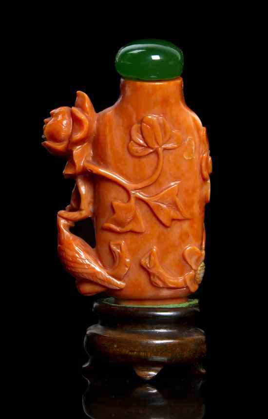 Appraisal: A Carved Coral Snuff Bottle having decoration of flowering peony