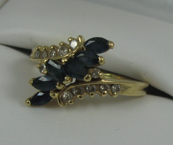 Appraisal: SAPPHIRE DIAMOND AND FOURTEEN KARAT GOLD RING set with six