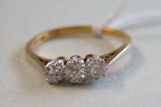 Appraisal: A gold and platinum diamond set three stone ring claw