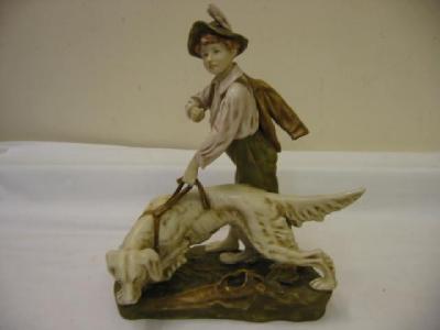 Appraisal: A ROYAL DUX BISQUE PORCELAIN GROUP of boy with setter