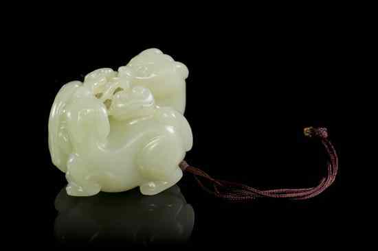 Appraisal: A Near White Jade Toggle of even colored stone depicting