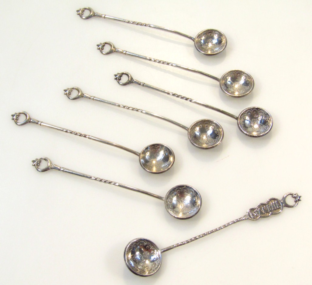 Appraisal: A set of seven Indian teaspoons with crescent handles and