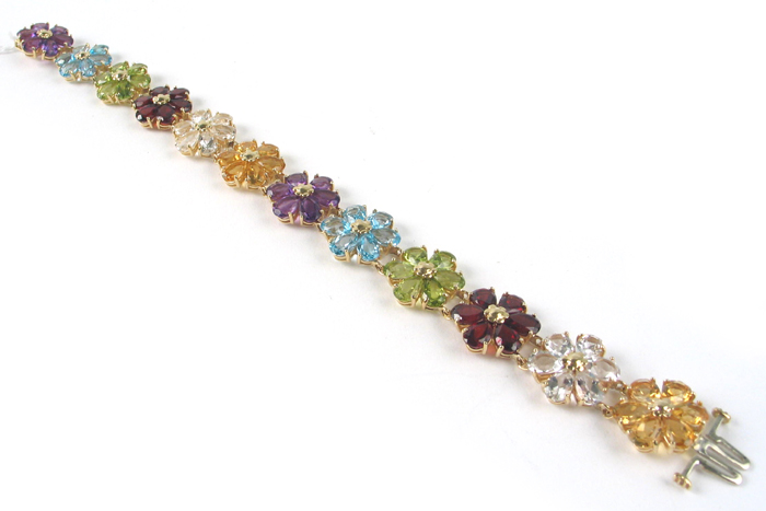 Appraisal: COLORED GEMSTONES AND FOURTEEN KARAT GOLD FLORAL BRACELET The seven