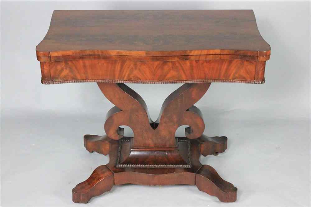 Appraisal: AMERICAN EMPIRE MAHOGANY GAMES TABLE circa the serpentine hinged top