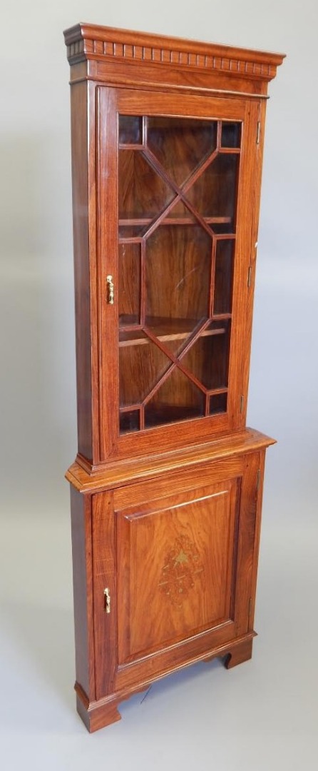 Appraisal: An Eastern hardwood and brass inlaid standing corner cabinet with