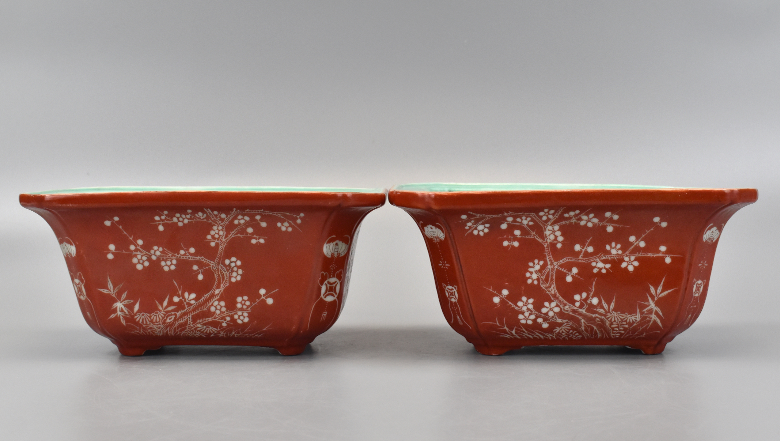 Appraisal: A pair of Chinese coral red glaze planter decorated with