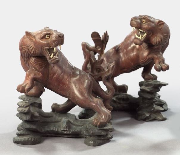 Appraisal: Pair of Japanese Meiji Elaborately Carved Wooden Figures of Snarling