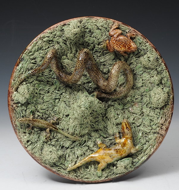 Appraisal: A PORTUGUESE PALISSY STYLE CHARGER the moss green ground applied