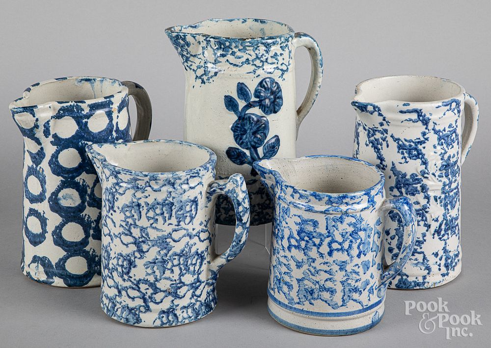 Appraisal: Five sponge decorated stoneware pitchers Five sponge decorated stoneware pitchers