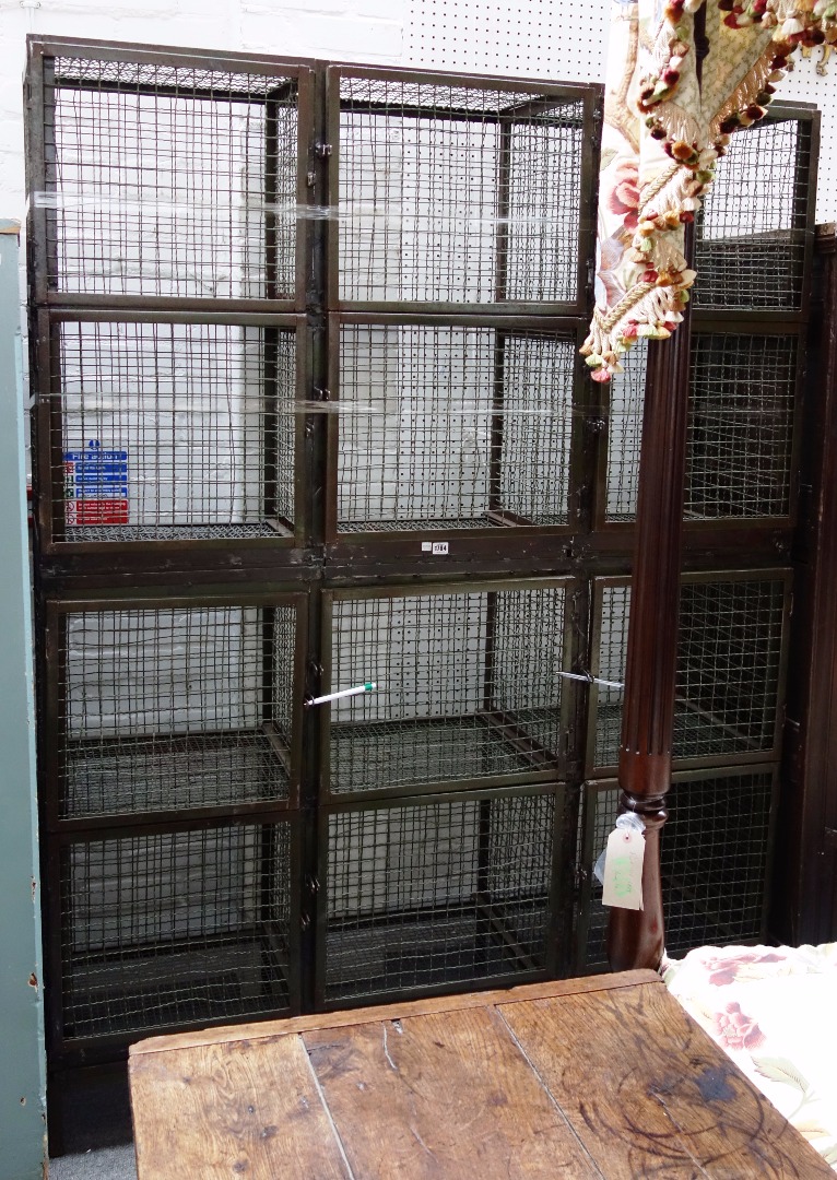 Appraisal: A th century wirework free standing twelve cupboard locker cabinet