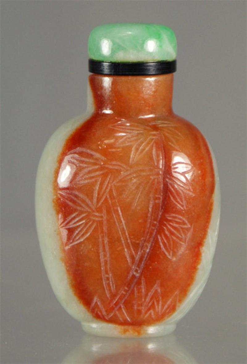 Appraisal: carved jadeite snuff bottle celadon and rust coloration scratch carved