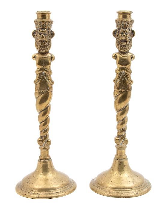 Appraisal: A Pair of Brass Figural Candlesticks Height inches A Pair