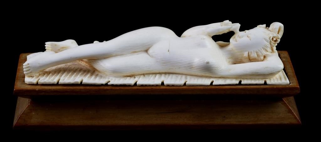 Appraisal: Carved antique ivory model of a nude woman on a