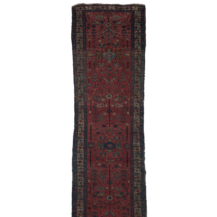 Appraisal: Persian runner c floral motif on a red field overall