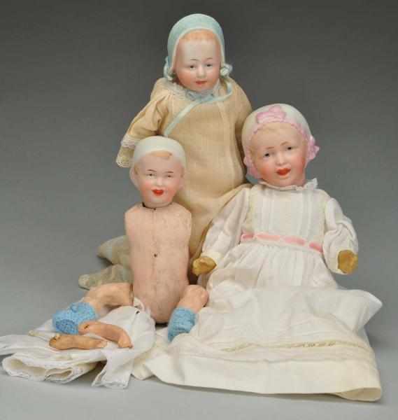 Appraisal: Three Babies with Molded Bonnets Description German bisque heads on