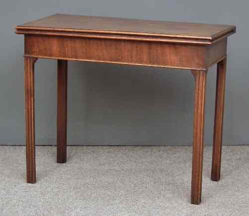 Appraisal: A George III mahogany tea table with plain folding top