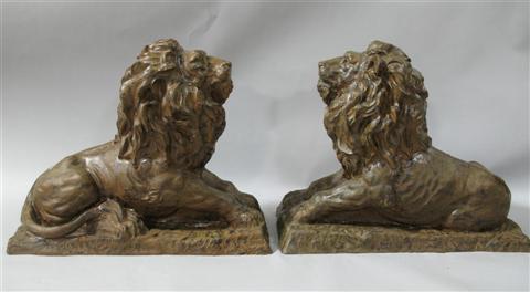 Appraisal: PAIR OF CAST IRON LIONS Seated in a recumbant pose