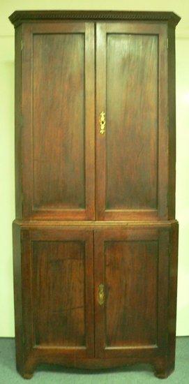 Appraisal: A late th Century mahogany corner cupboard the top with