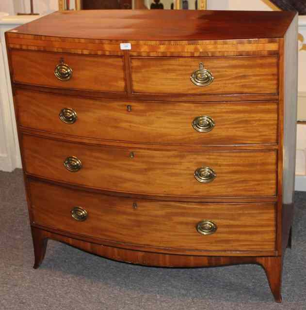 Appraisal: A GEORGIAN MAHOGANY BOW FRONT CHEST of three long two