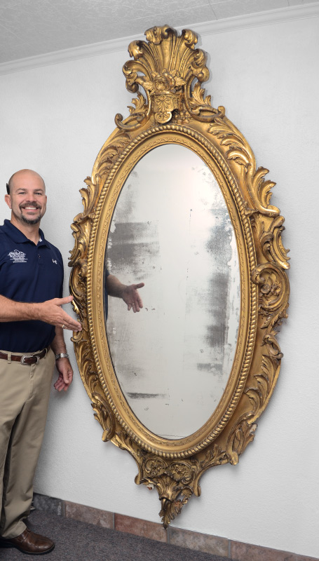 Appraisal: LARGE CARVED AND GILDED OVAL MIRROR In the Rococo style