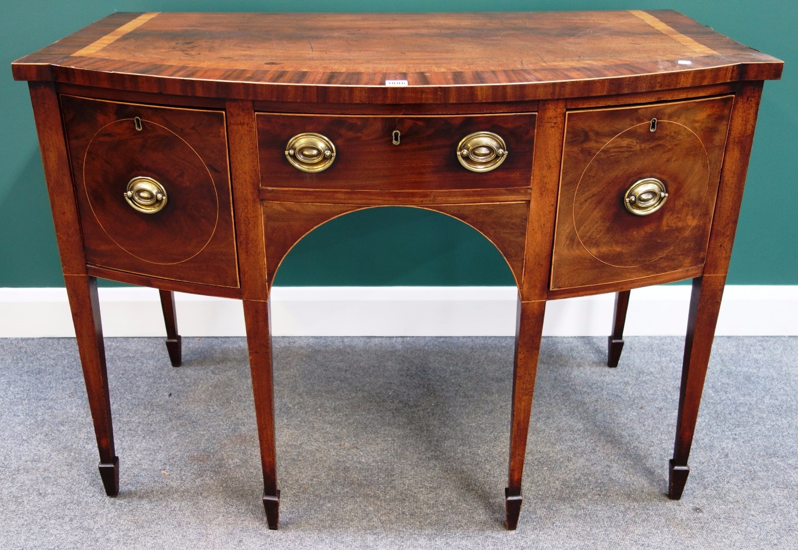 Appraisal: A George III mahogany bowfront side table with three frieze