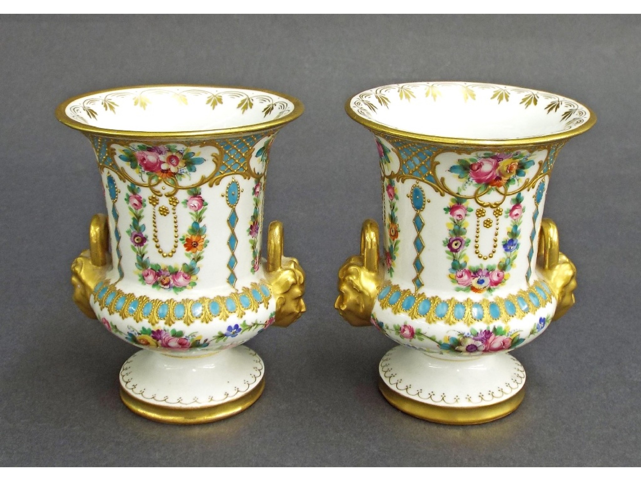 Appraisal: Pair of French porcelain twin-handled vase urns in the manner