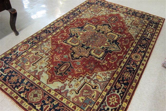 Appraisal: HAND KNOTTED ORIENTAL CARPET Persian Serapi design central geometric medallion