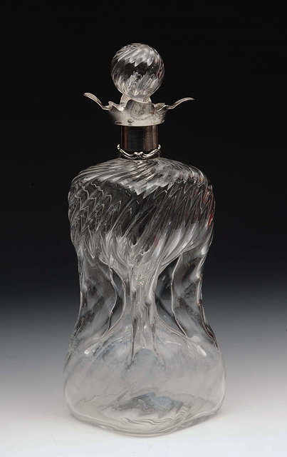 Appraisal: A SILVER MOUNTED GLASS DECANTER with wrythen and waisted body