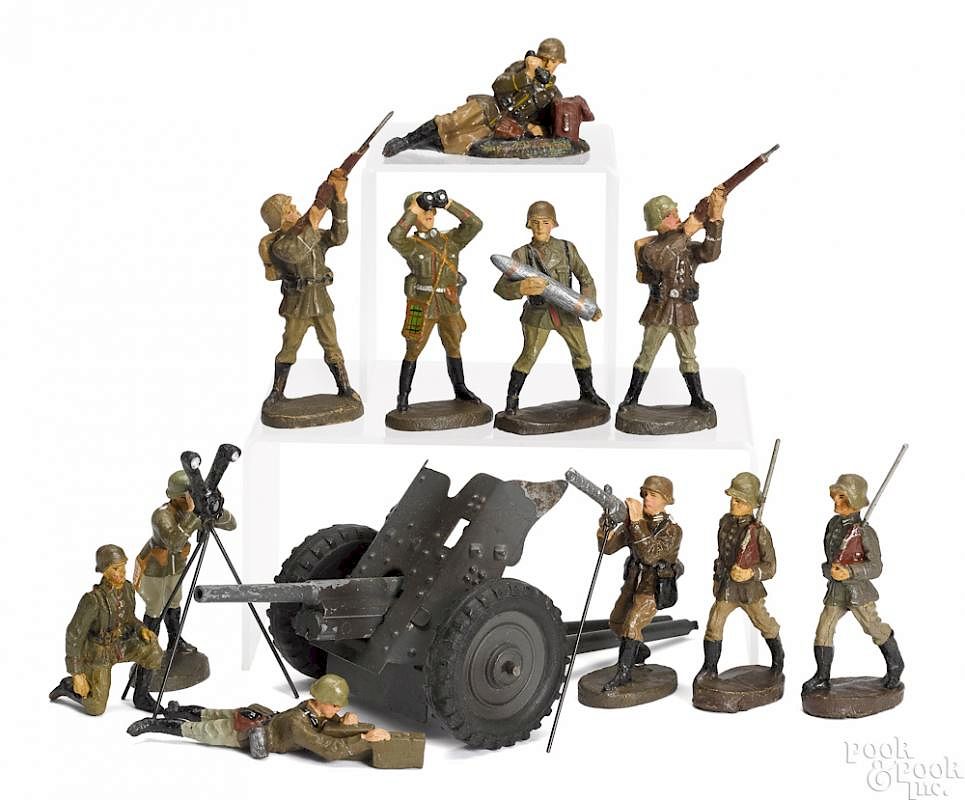 Appraisal: Elastolin painted tin gun and composition soldiers Elastolin painted tin