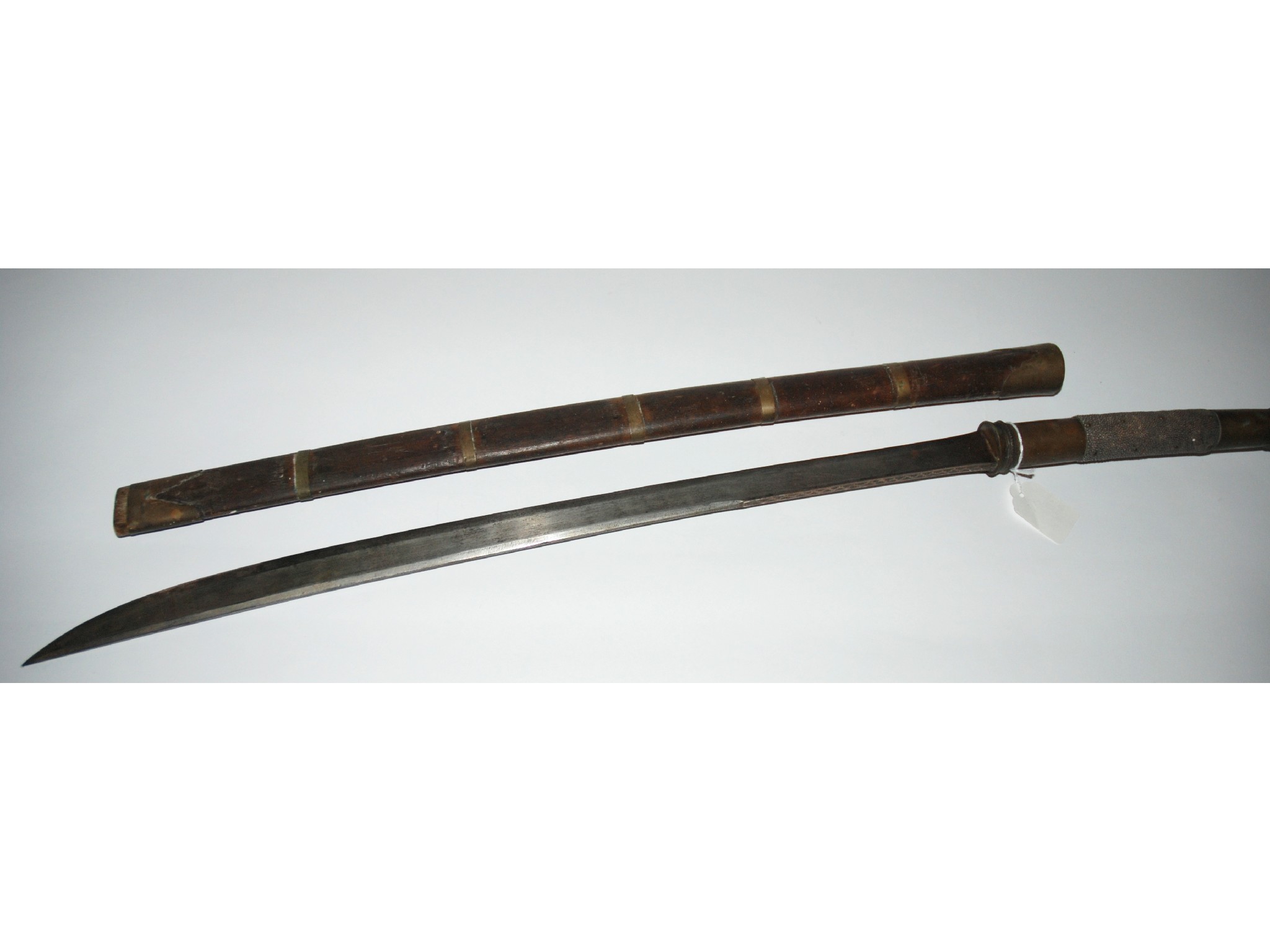 Appraisal: A Burmese sword in wooden and brass bound scabbard