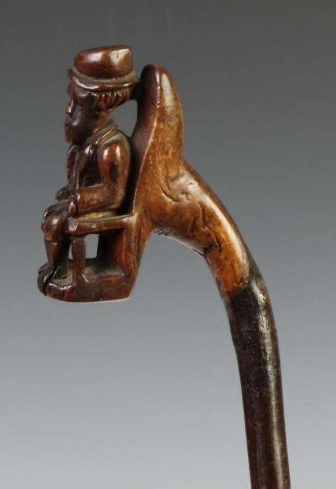 Appraisal: Carved Cane w Seated Gentleman Coat Hat th cent