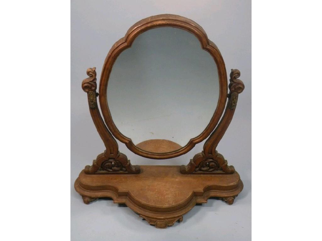 Appraisal: A Victorian walnut dressing table mirror with a shaped plate