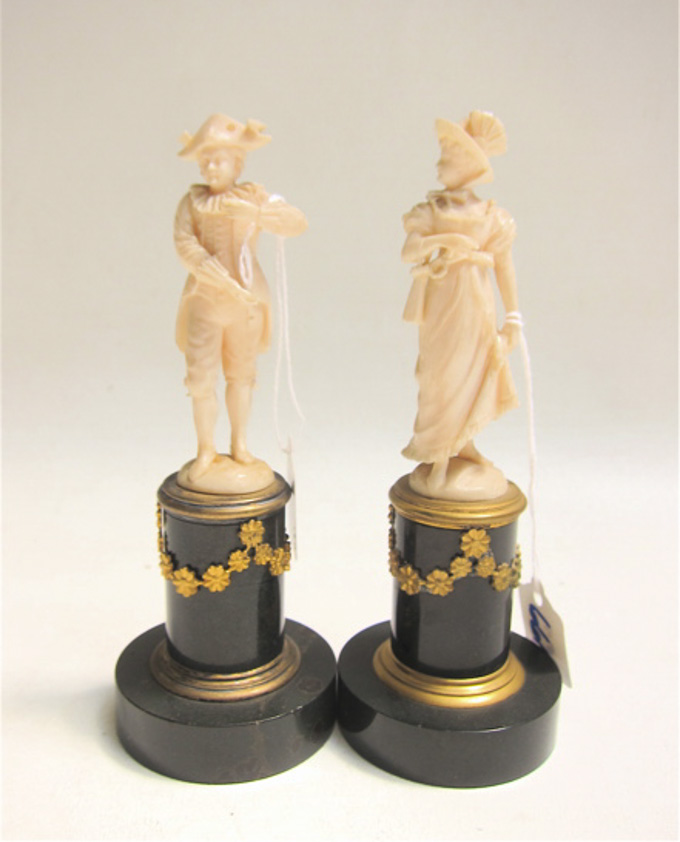 Appraisal: TWO CLASSICAL REVIVAL CARVED IVORY FIGURALS of a Regency style