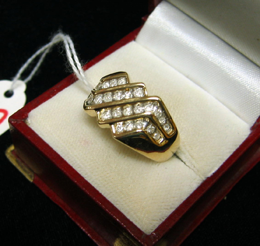 Appraisal: MAN'S DIAMOND AND TEN KARAT GOLD RING set with channel