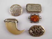 Appraisal: A mixed lot comprising four white metal tests silver brooches