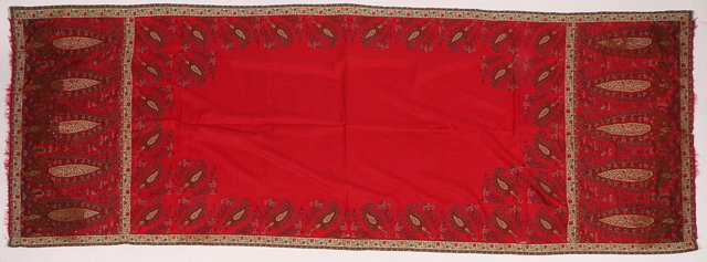 Appraisal: A NORWICH RED SILK SHAWL with stylised peacock feather decoration