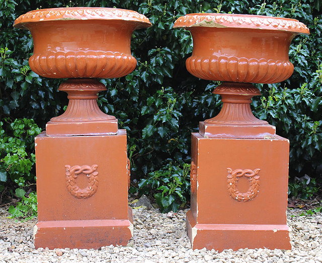 Appraisal: A PAIR OF VICTORIAN BROWN GLAZED URNS OF CAMPANA FORM