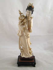 Appraisal: A Chinese ivory figure of a young lady with branch