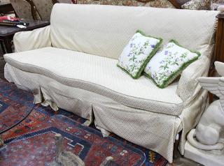 Appraisal: Moderne sofa having a square profile with slipcover upholstered in