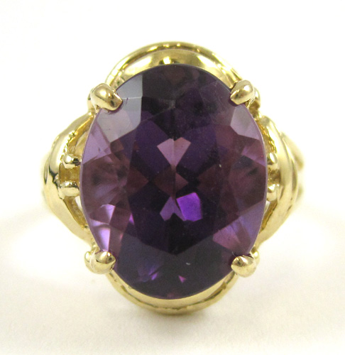 Appraisal: AMETHYST AND FOURTEEN KARAT GOLD RING set with an oval-cut