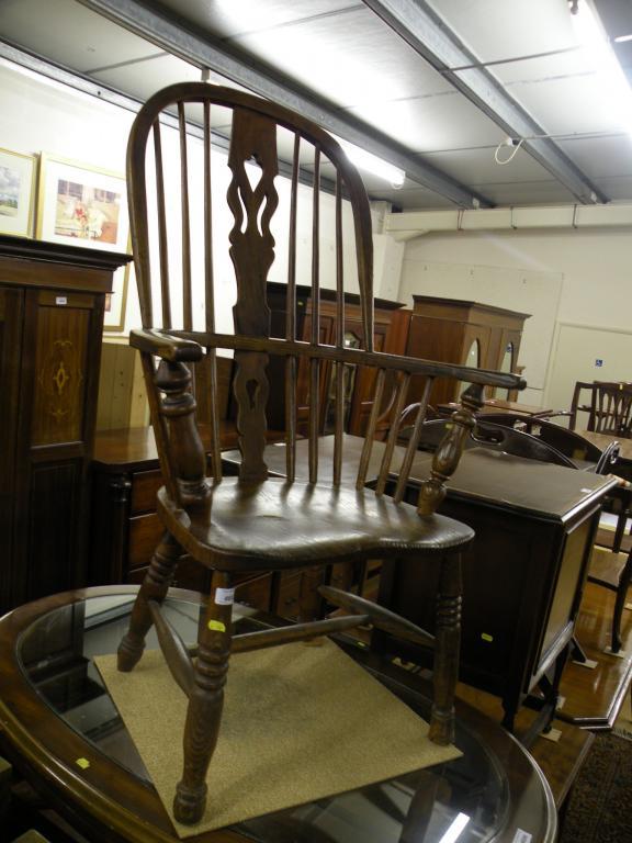 Appraisal: A thC ash and elm windsor armchair with a pierced