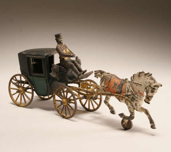 Appraisal: Cast iron horse drawn carriage two tone body white bob