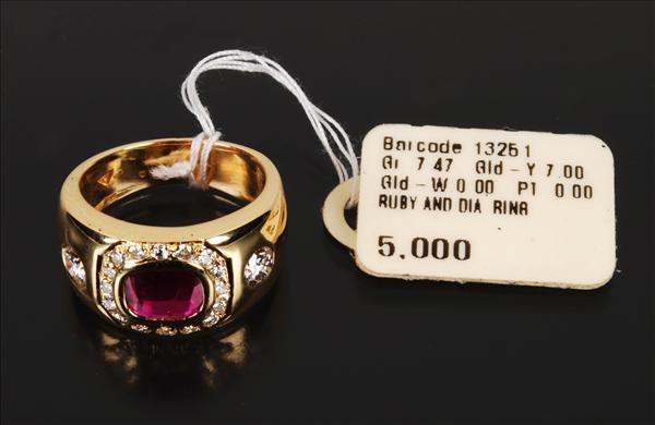 Appraisal: A ruby and diamond band ring the central rectangular mixed