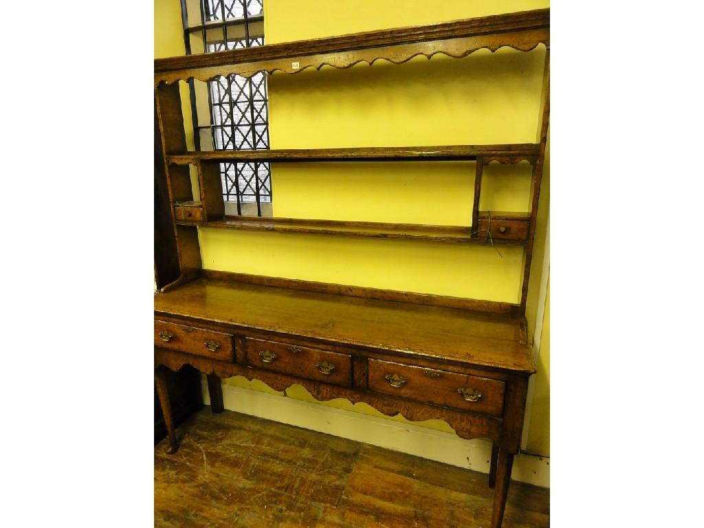 Appraisal: A good quality reproduction distressed oak dresser by Titchmarsh Goodwin