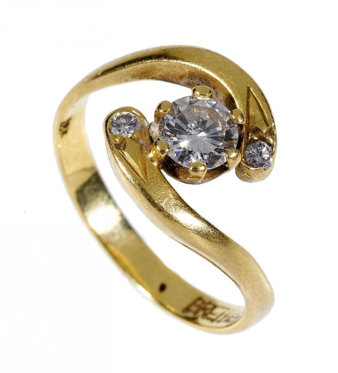 Appraisal: A DIAMOND RING of crossover design with a larger round