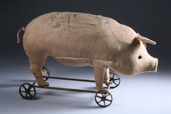 Appraisal: PIG-ON-WHEELS PULL TOY Shoe button eyes velvet nose iron wheels