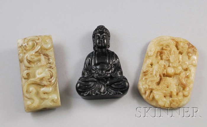 Appraisal: Three Asian Jade and Carved Stone Pendants on a seated