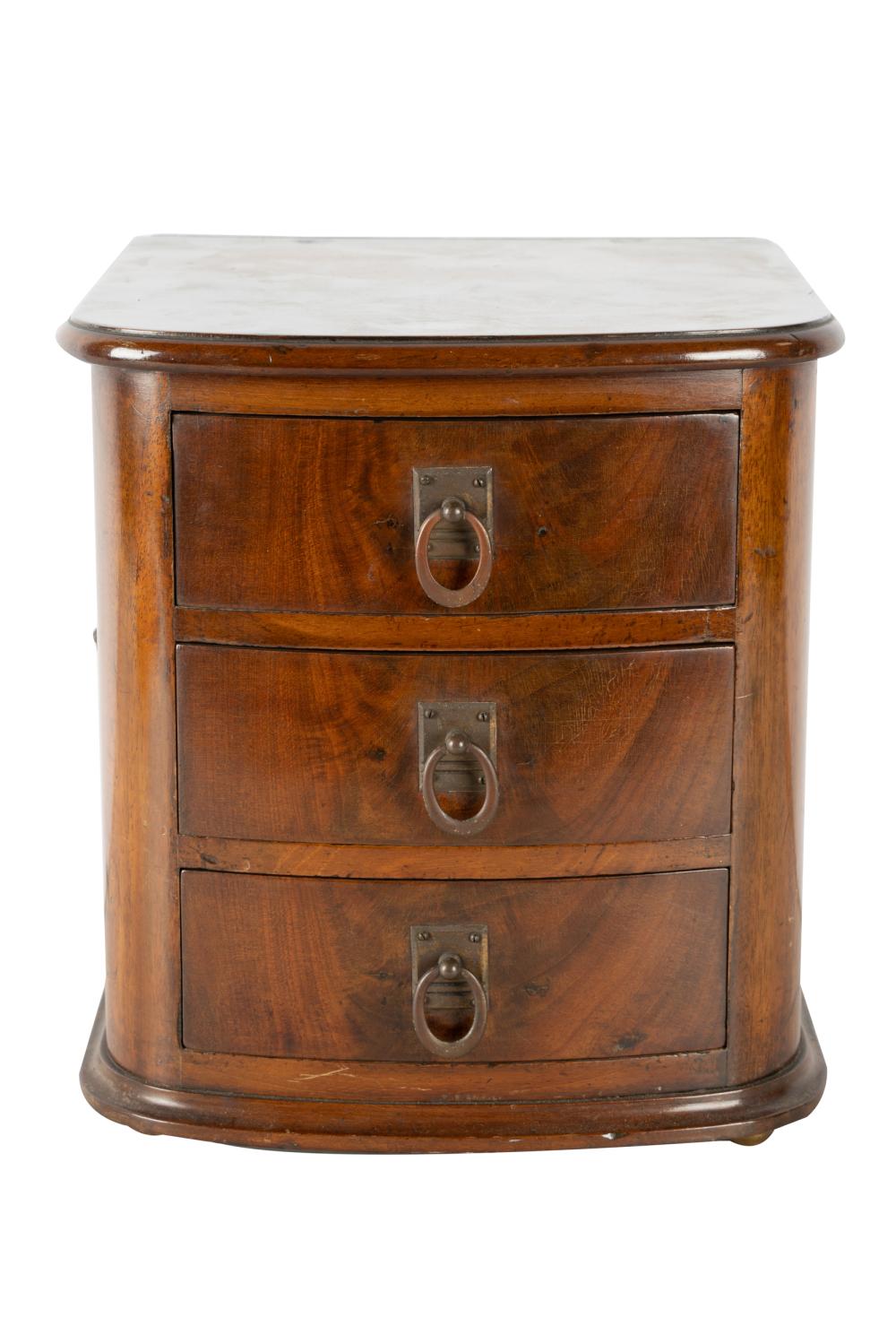 Appraisal: DIMINUTIVE CARVED MAHOGANY COMMODEwith three drawers inches square inches high