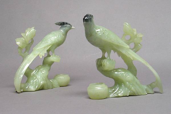 Appraisal: Two carved serpentine long-tailed birds on tree stumps Each sculpture