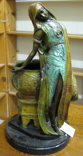 Appraisal: PATINATED FIGURAL BRONZE SCULPTURE Arab girl standing against a bronze